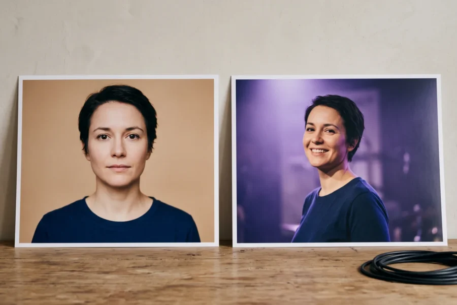 Two prints of the same fictional woman, one neutral portrait and one smiling under violet studio light, beside a coiled audio cable